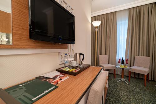a hotel room with a large flat screen tv at The Green Park Diyarbakir in Diyarbakır