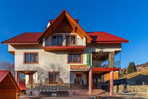 a large house with a red roof at Гуцульська світлиця in Bukovel