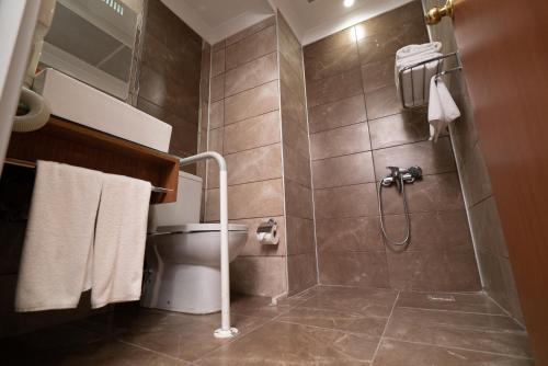 a bathroom with a shower and a toilet at The Green Park Diyarbakir in Diyarbakır