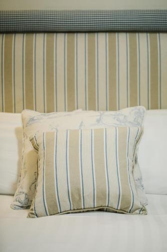 a pillow sitting on top of a bed at The Old Fourpenny Hotel in Warwick