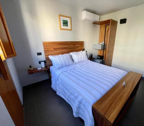 a bedroom with a large bed with a striped bedspread at Casa Olié in Oaxaca City