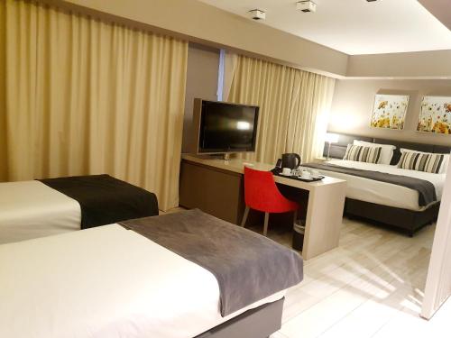 En eller flere senge i et værelse på GrandView Hotel Buenos Aires