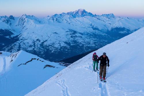 two people hiking up a snow covered mountain at Club Alpina - Champagny-en-Vanoise in Champagny-en-Vanoise