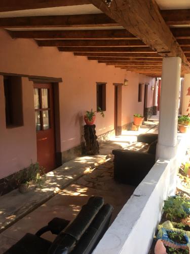 a patio of a house with couches at Hostal Puritama in San Pedro de Atacama