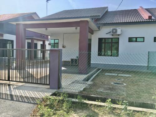 a house with a fence in front of it at Arwaa Homestay Beachview in Bachok