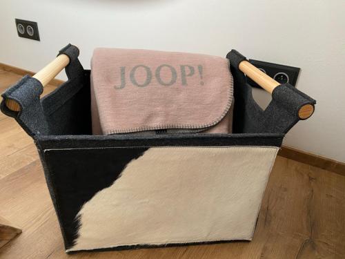 a black and white toolbox with a towel and chopsticks at Chalet Apartments Maštal in Železná Ruda
