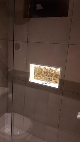 a window in a glass case in a room at Pippo Suites Guarujá in Guarujá