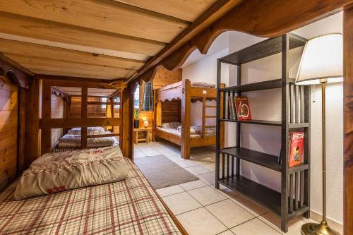 a room with several bunk beds and a lamp at Gîte Ancolie Bleue in Abriès