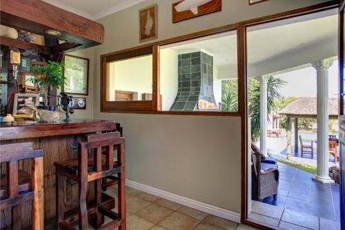 
a kitchen with a window and a dining room table at Waterfront Lodge in Knysna
