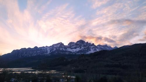 a view of a mountain with the sun setting at Loft Casa Berdón in Panticosa