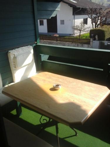 a wooden table sitting on top of a balcony at Appartment Andrea in Eugendorf