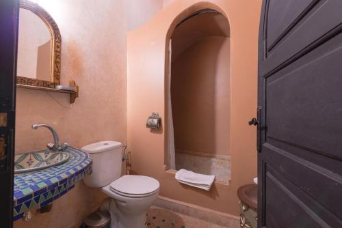 a bathroom with a toilet and a sink at Riad Lalla Khiti in Marrakesh