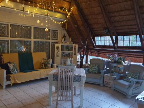 a living room with a table and chairs at Chic Breeze in Bloemfontein