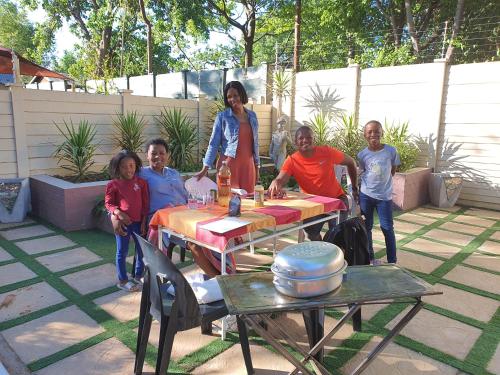 a group of people standing around a table at Chic Breeze in Bloemfontein