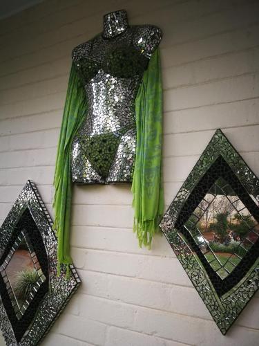 a dress hanging on the side of a wall with mirrors at Chic Breeze in Bloemfontein
