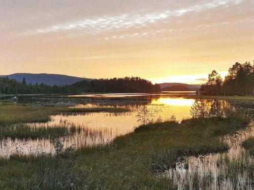 a large body of water with a sunset in the background at Tranquil Retreat in Halsingland-By Traum in Kårböle