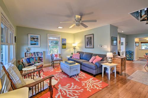 a living room with a couch and a ceiling fan at Classic Chesapeake Beachside Cottage with Porch! in Norfolk