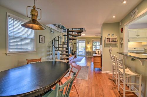 a dining room and kitchen with a table and chairs at Classic Chesapeake Beachside Cottage with Porch! in Norfolk