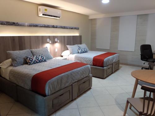 Giường trong phòng chung tại EXECUTIROOMS VERACRUZ