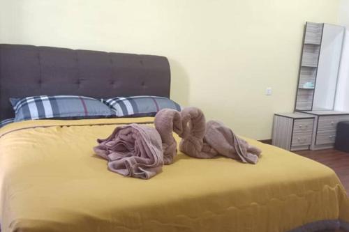 a bed with two towels on top of it at KS 80 Homestay (15pax)4R3B ~WiFi~ near Jetty in Kuala Selangor