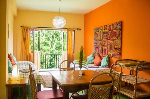 a living room with a table and chairs at Chrissie's Hotel in Thekkady