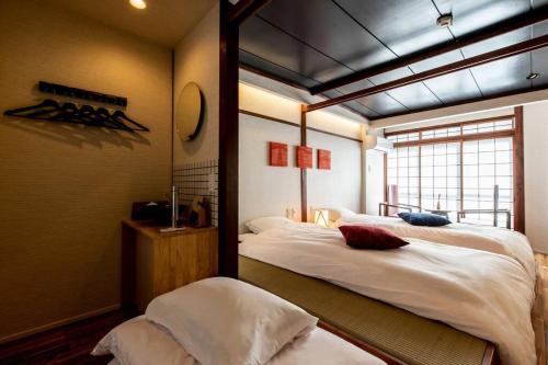Giường trong phòng chung tại Tabiyado Chirin