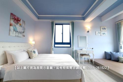 a white bedroom with a bed and a window at Zen Ocean in Jian