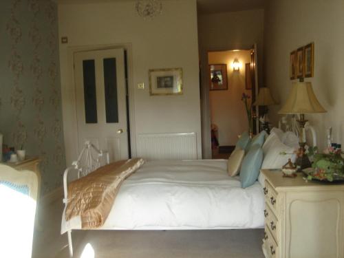 a bedroom with a large white bed in a room at Littlebank Country House in Settle