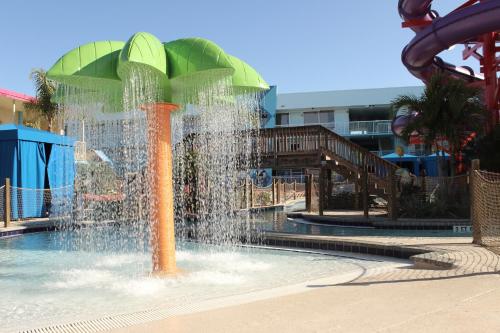 a water fountain in a water park with a slide at Ramada by Wyndham Flamingo Water Park in Kissimmee