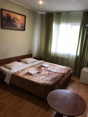 a bedroom with a large bed and a window at Славна Кача in Odesa