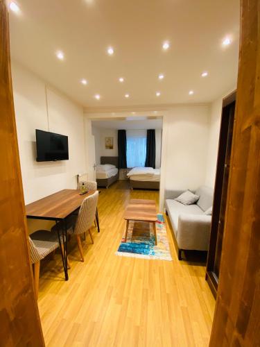 a living room with a table and a couch at Akomo Bern in Bern