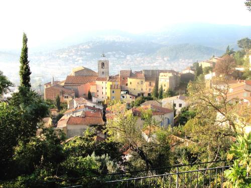 a small town on a hill with buildings at Hôtel Lido Beach in Hyères