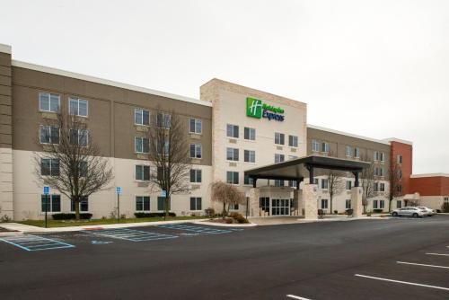 a hotel building with a gas station in a parking lot at Holiday Inn Express Wixom by IHG in Wixom