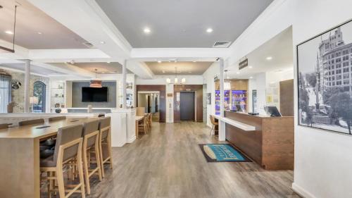 a lobby of a restaurant with a bar and tables at Staybridge Suites Savannah Historic District by IHG in Savannah