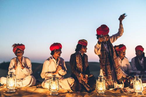 a group of men sitting around a table with lights at Suryagarh Jaisalmer in Jaisalmer