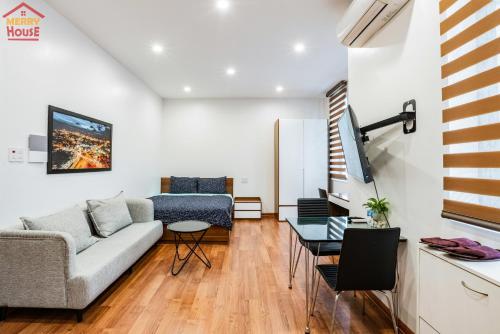 a living room with a couch and a table at Merry House Imperia in Hai Phong
