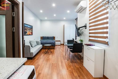 a living room with a couch and a table at Merry House Imperia in Hai Phong