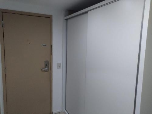 a door in a room next to a wall at Flat beira mar, Olinda 4 Rodas 309 in Olinda