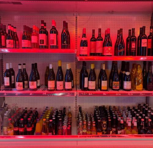a display case filled with bottles of wine at The Sun&Soul Panorama Pop-Up Hotel Solsana in Gstaad