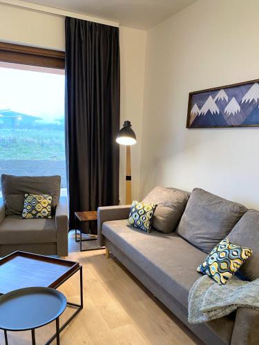 a living room with a couch and a table at Panorama Home Valča in Stará Turá
