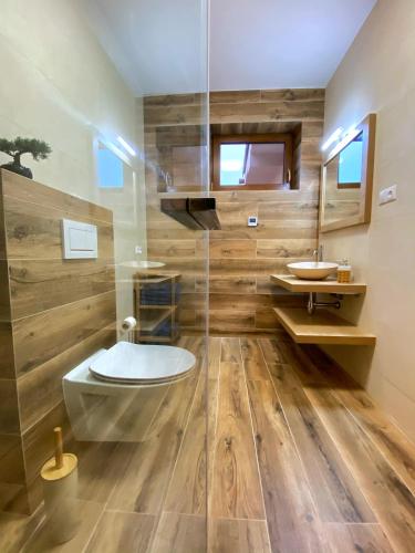 a bathroom with a toilet and a sink at Panorama Home Valča in Stará Turá