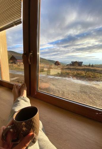 a person sitting in front of a window looking out at Panorama Home Valča in Stará Turá