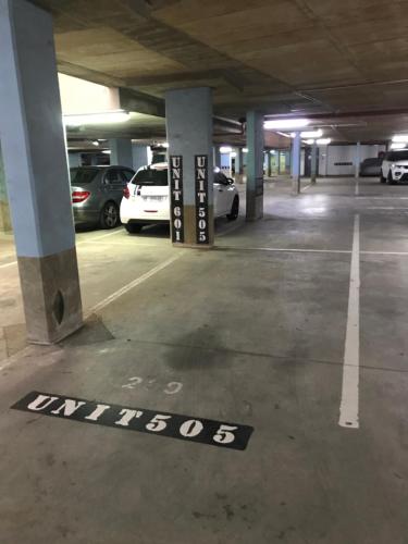a parking lot with cars parked in a parking garage at Durban Point Waterfront, 505 Quayside 40 Canalquay Rd in Durban