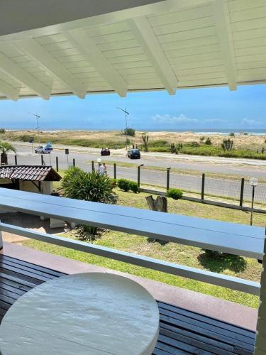 un banco blanco en un porche con vistas a la autopista en Casa Beira Mar, en Torres