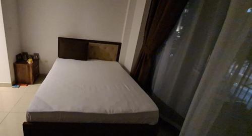 a small bed in a room with a window at TOWER 2 DOWNTOWN APARTMENT 29 BOULEVARD in Dubai