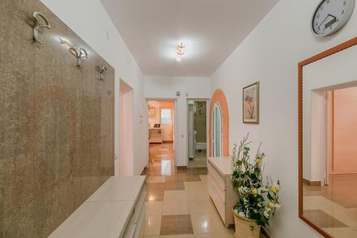 a hallway of a home with a bench and a mirror at Palm Point Apartment in Petrovac na Moru
