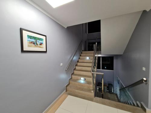 a staircase in a house with a picture on the wall at Royale Suites by Arc Royal Luxury Apts in Anse Royale