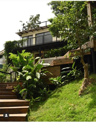a house with a balcony on top of it at Vila Bambu Ilhabela, Santa Tereza in Ilhabela