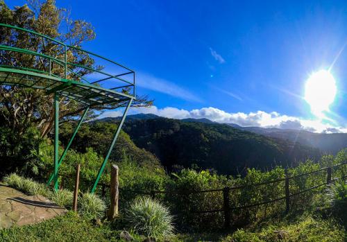 a view of a mountain with the sun in the sky at Rainbow Valley Lodge Costa Rica in Monteverde Costa Rica
