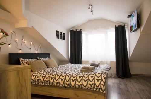 a bedroom with a bed with black curtains at Central Sweet Home I.M. in Novi Sad